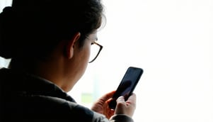person looking at or holding a cell phone