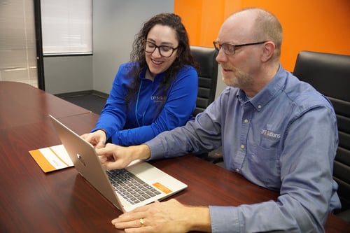 employees looking at accounting software in an office