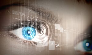 Eye viewing digital information represented by circles and signs