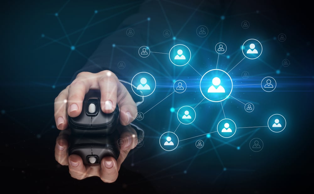 Hand using wireless mouse in a dark environment with human network concept