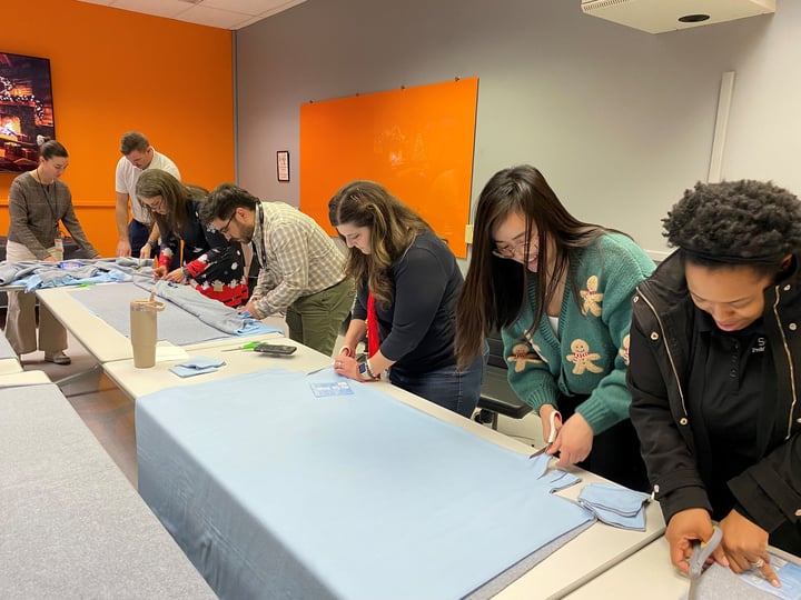 DP Solutions Team making tie blankets for Miriam's Kitchen