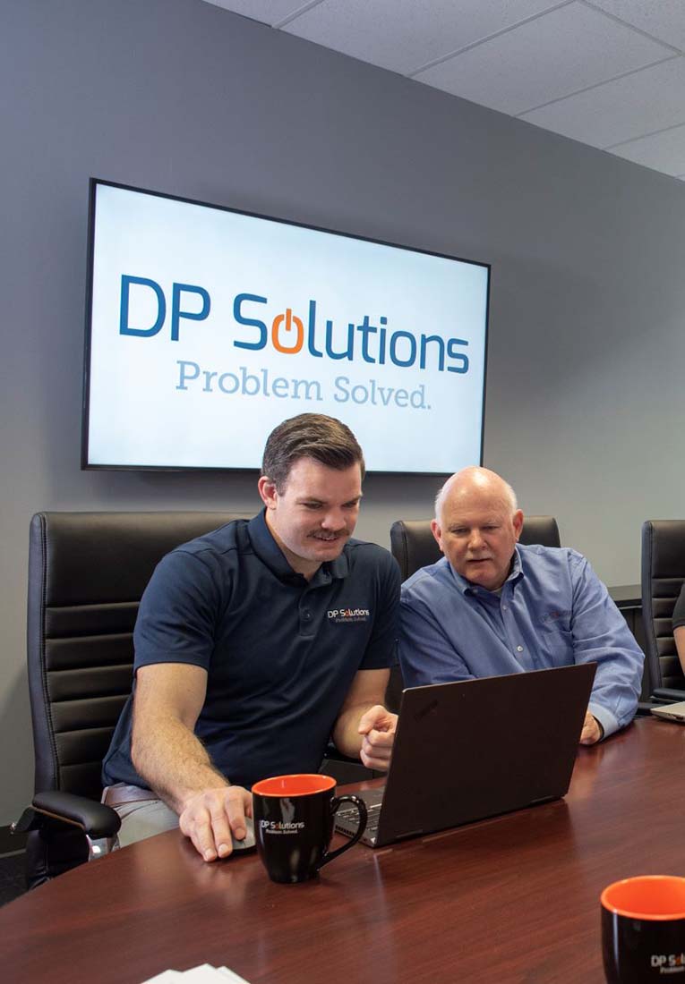dp-solutions-team-in-conference-room-tall-1