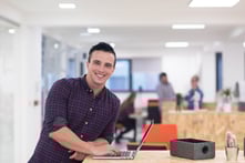 portrait of young businessman in casual clothes at modern startup business office space, working on laptop computer-1